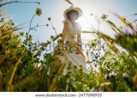 Similar – Image, Stock Photo Cute girl touching flowers in a french lavender field at sunset