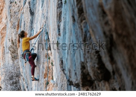 Similar – Image, Stock Photo Woman in a rock facing the sea doing a variation of handstand yoga pose