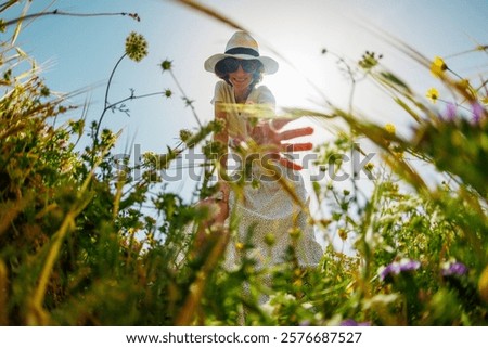 Similar – Image, Stock Photo Cute girl touching flowers in a french lavender field at sunset