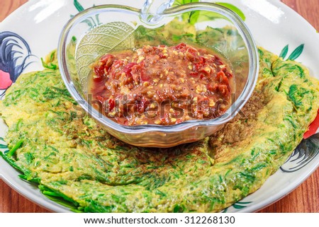 close up acacia omelette (Cha-om khai ) Thai food pattern with Shrimp Paste Sauce (Nam Prik Ka Pi)