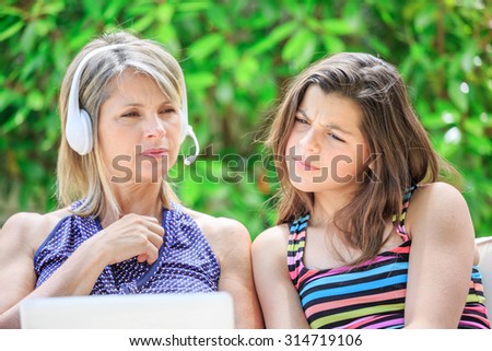 View of a happy mother and daughter in a video conference