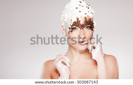 Portrait of beautiful girl with trendy make-up with coffee beans and cream