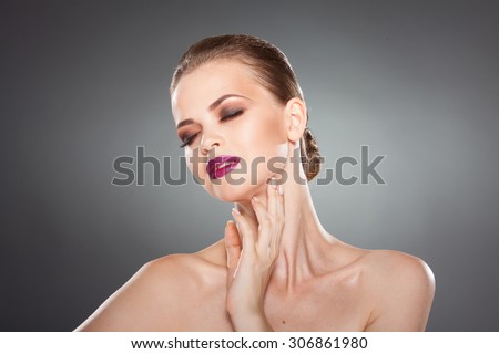 beautiful girl touches her face. close-up studio portrait isolated on white. youth and health. skin care.