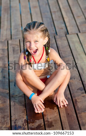 smiling cute girl on a timber floor