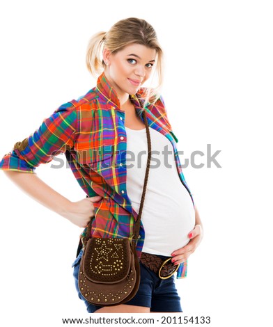 Beautiful pregnant white woman wearing shirt with hands on belly isolated on a white background