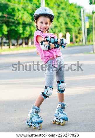 Little girl on roller skates at park