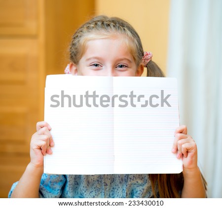 Close up portrait of a young girl holding blank sign