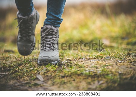 feet in shoes on a forest path