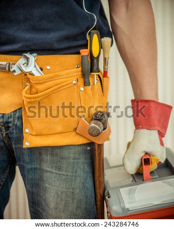 man with tools in leathern belt