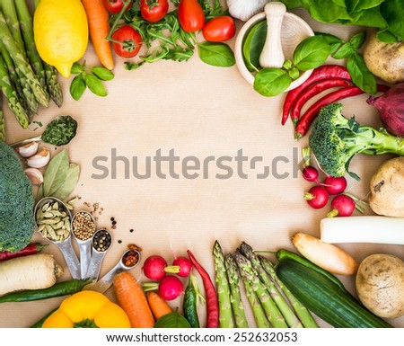 Frame of Fresh vegetables on a brown background