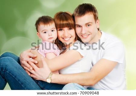 happy family with a baby on a color background