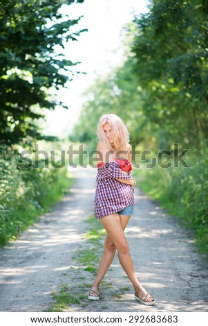 Full figure shot of playful young attractive blonde pink girl