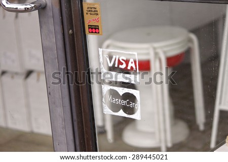 HELSINKI, FINLAND - JUL 6, 2010: Photo of VISA and Mastercard credit card logos hand drawn on the glass door. VISA and Mastercard is an American multinational financial services corporation