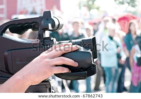Television camera man filming a political rally