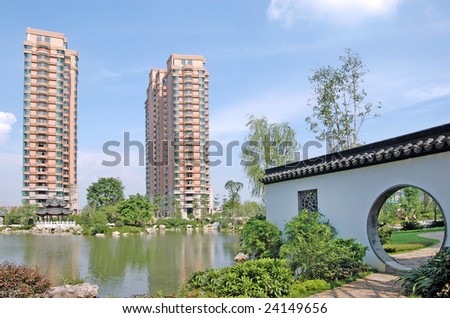 Two upscale apartment blocks by the lakeside, the road leads to the apartment community garden