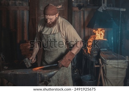 Similar – Image, Stock Photo Blacksmiths forging hot metal with hammer in workshop