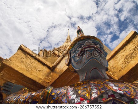 Sculpture of color full Ramayana Giant guard the gold pagoda under cloudy sky. the nice decorated Ramayana blue skin Giant is one of the character from Ramayana story tale from Hindu religion.