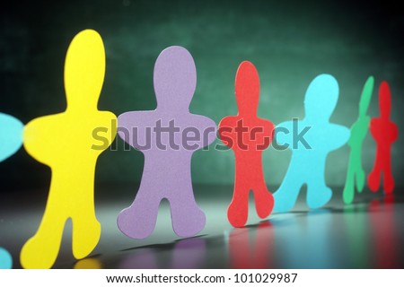 multi color paper cut-out men in a row