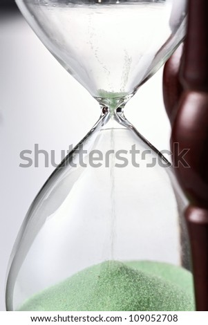 Sand funneling through hour glass