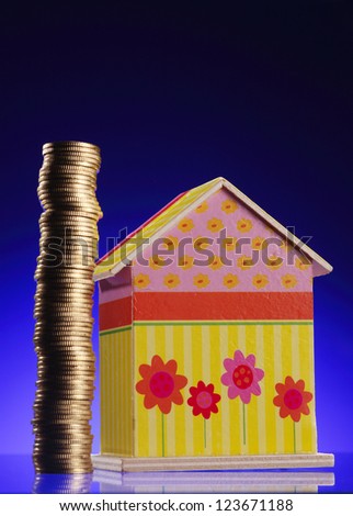 stack of coin and coin doll house