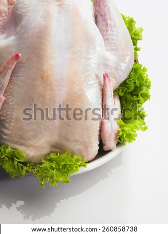 Raw whole chicken with garnishing