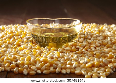 maize corn and glass of heart shape container filled up with corn oil