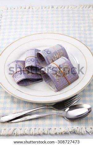 Conceptual composition, white plate full of malaysia money.