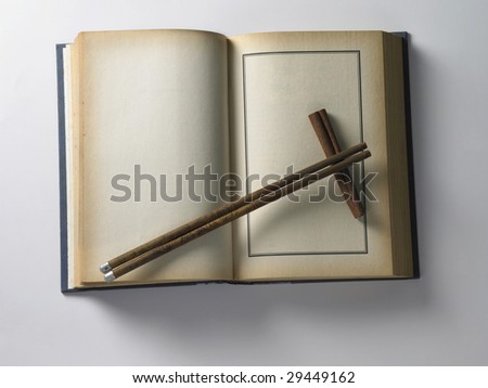 chopstick set on  book at the plain background
