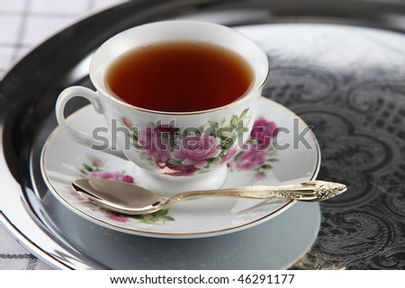 cup of tea on the silver serving tray