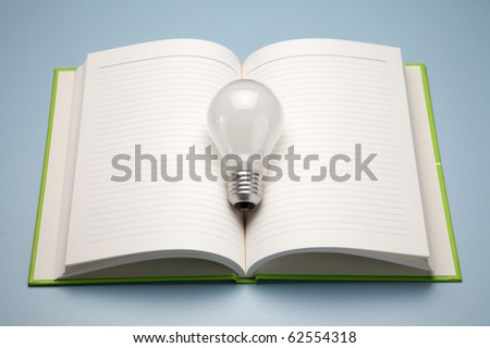 A book and lamp, isolated on dark background for concept idea