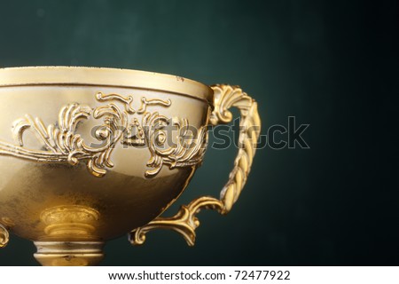 Trophy cup isolated on the green background.
