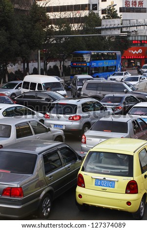KUNMING, CHINA - FEBRUARY 7: Bottleneck in Kunming CBD. With more than 13 million cars sold in China last year cars are a major factor in China\'s air pollution. Kunming, Feb. 7, 2013.