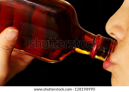 Close Up of a Young Woman Drinking Hard Liquor from the Bottle