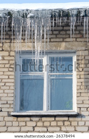 Hanging icicles on eaves beside window