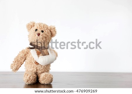 teddy bear with broken arm