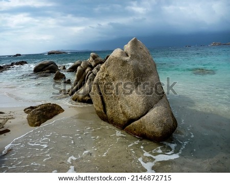 A day of uncertain weather on Maddalena Island in Sardinia. Cloudy skies and green waters make the perfect background for these weird rock formations... They always looked to me like an ancient sea cr Photo stock © 