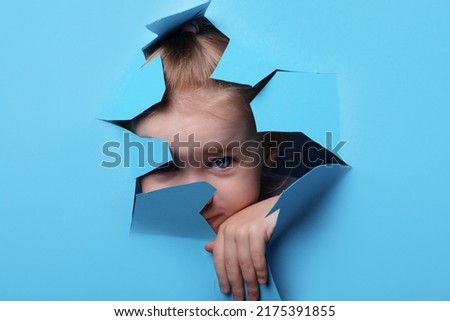 Similar – Image, Stock Photo Child looks through hole in snow