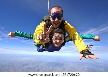 Skydiving. Courageous woman flying through the skies.