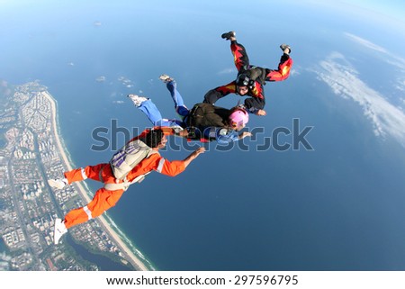Woman learning skydiving in Brazil . Above the sea and the beach