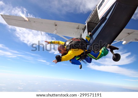 Skydivers tandem jump from the plane