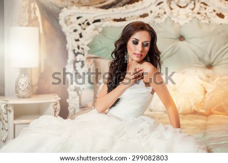 Beautiful woman bride in white wedding dress in bedroom