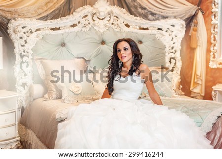 Beautiful woman bride in white wedding dress in bedroom
