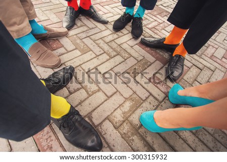 Funny colorful wedding shoes and socks on people legs
