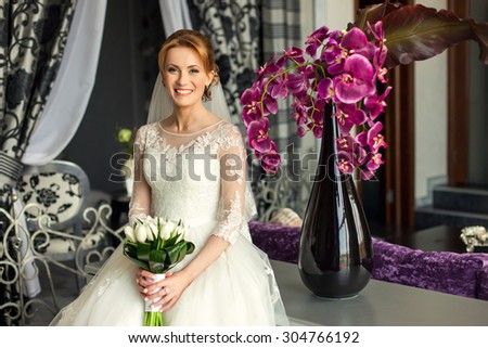 Woman bride in luxury interior on her wedding with bouquet