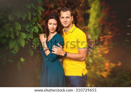 Couple in love: man and woman in colorful fantastic autumn forest