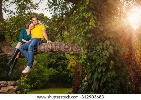 Couple in love: man and woman in colorful fantastic autumn forest