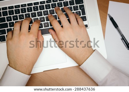 Businessman in office performing the action of writing on the computer.