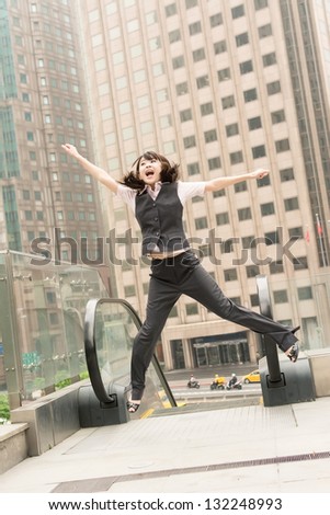 Business woman jump and excited in outside of modern city.