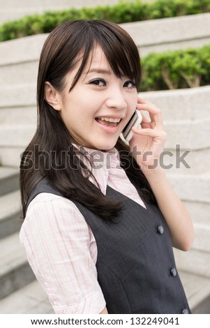 Business woman of Asian talk on cellphone, closeup portrait in urban.