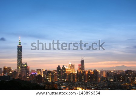 Taipei city night with famous landmark, 101 skyscraper, under blue and dramatic colorful sky in Taiwan, Asia.